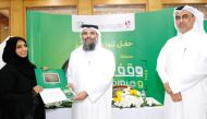Undersecretary of the Ministry of Awqaf and Islamic Affairs Dr. Sheikh Khalid bin Mohammed bin Ghanem Al Thani (centre) honouring a winner.