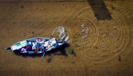 An aerial view shows people paddling through a flooded street in South Daytona, Florida, following the passage of Hurricane Milton on October 11, 2024. (Photo by Miguel J Rodriguez Carrillo / AFP)