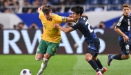 Australia's Jordan Bos (L) and Japan's Takefusa Kubo compete for the ball during the FIFA World Cup 2026 Asian zone qualifiers football between Japan and Australia at Saitama Stadium in Saitama on October 15, 2024. (Photo by Philip FONG / AFP)