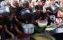 Displaced Palestinians queue to receive food rations, offered by a charity, in Gaza's Al-Shati refugee camp on October 17, 2024. Photo by Omar AL-QATTAA / AFP