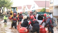 This handout photo taken by the UME - Spanish Military Emergencies Unit shows Spanish rescuers taking residents on a dinghy boat following deadly flooding, in Valencia, on October 30, 2024. (Photo by Handout / UME / AFP)
