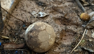 A ball lies on the mud at a flood damaged sports center in Paiporta, in the region of Valencia, eastern Spain, on November 10, 2024. 130,000 people marched yesterday in Valencia to voice their anger at the authorities' handling of deadly floods as thousands also marched in other Spanish cities. (Photo by JOSE JORDAN / AFP)
