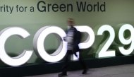 Attendees walk past the COP29 logo during the United Nations Climate Change Conference (Cop29) in Baku, Azerbaijan, on November 21, 2024. (Photo by STRINGER / AFP)

