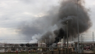 Smoke billows after a fire broke out at a fuel depot run by Italian energy company Eni in Calenzano, near Florence, on December 9, 2024. (Photo by Claudio GIOVANNINI / ANSA / AFP)