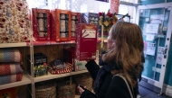 A customer browses Christmas crackers inside an Oxfam charity shop in London, on December 18, 2024. Photo by BENJAMIN CREMEL / AFP
