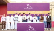 The connections of Warming celebrate after landing the Qatar Oaks at Al Uqda Racecourse yesterday. 