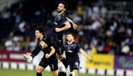 Qatar SC players celebrate after defeating Al Sadd yesterday.