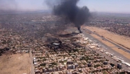 (FILES) This image grab taken from AFPTV video footage on April 20, 2023, shows an aerial view of black smoke rising above the Khartoum International Airport amid ongoing battles between the forces of two rival generals. (Photo by AFP)
