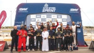 Podium winners of second round pose with their trophies. 