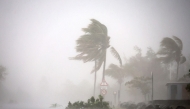 This photograph shows the passage of rain and wind across a road in Saint-Paul de La Reunion, on the French overseas Indian Ocean island of La Reunion, on February 28, 2025. Photo by Richard BOUHET / AFP.
