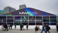 People walk towards the entrance of the MWC (Mobile World Congress), the world's biggest mobile fair, in Barcelona on March 3, 2025. (Photo by Manaure QUINTERO / AFP)
