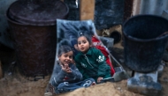 Karam Haloub's kids are seen near their damaged house in Beit Lahia in the northern Gaza Strip, on March 3, 2025. (Photo by Rizek Abdeljawad/Xinhua)
