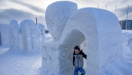 A young Greenlander plays among snow sculptures in Nuuk, Greenland, on March 4, 2025. (Photo by Odd Andersen / AFP)
