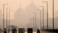 (Files) Commuters ride along a street engulfed in smog, in Lahore on November 5, 2024. (Photo by Arif Ali / AFP)