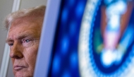 US President Donald Trump speaks to journalists aboard Aire Force One as he travels from West Palm Beach back to Washington on March 9, 2025. (Photo by Roberto Schmidt / AFP)
