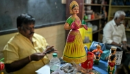A hand-painted Channapatna doll displayed for sale at artisan Venkatesh's toy store in Channapatna in the Ramanagara district of India's Karnataka state. (Photo by Idrees Mohammed / AFP) 