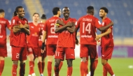 Al Duhail players celebrate their win over Al Gharafa. 