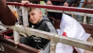 A boy sits in the back of a tricycle cart with sacks of flour provided by the Turkish disaster relief agency AFAD, received from a supply centre affiliated with the United Nations Relief and Works Agency for Palestine refugees (UNRWA) in al-Tifah neighbourhood of Gaza City on April 1, 2025. Photo by Bashar TALEB / AFP