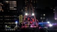 The wreckage of a helicopter is removed from the water after crashing into the Hudson River, in the Newport neighborhood of Jersey City, New Jersey, on April 10, 2025. (Photo by Leonardo Munoz / AFP)
