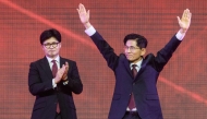 Former labour minister Kim Moon-soo (R) celebrates next to ex-party chief Han Dong-hoon after winning the final race to choose South Korea's conservative People Power Party's (PPP) candidate on May 3, 2025. (Photo by Anthony Wallace / AFP)