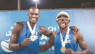 Qatar’s Cherif Younousse and Ahmed Tijan celebrate with their medals.