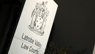 The Victorian Coat of Arms is seen outside the Latrobe Valley Magistrates' Court in Morwell, south of Melbourne, on April 30, 2025. Photo by Martin KEEP / AFP.
