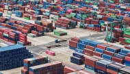 Shipping containers are stacked at a port in Shanghai on May 9, 2025. Photo by AFP