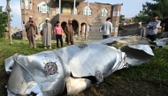 People watch an unclaimed part of an aircraft at Wuyan village in Pulwama district, about 20 km south of Srinagar city, the summer capital of Indian-controlled Kashmir, May 7, 2025. (Xinhua/Javed Dar)
