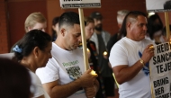 Carlos Valle (C), husband of Heidy Sanchez attends a vigil in support of Sanchez and to honor all mothers who have been separated form their children because of deportations at Centennial Park in Tampa, Florida, on May 10, 2025. (Photo by OCTAVIO JONES / AFP)
