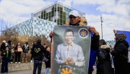 A supporter holds a portrait of former Philippine president Rodrigo Duterte in front of the International Criminal Court (ICC) in The Hague, Netherlands, on March 14, 2025. (Photo by Nicolas Tucat / ANP / AFP)
