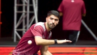Qatar’s Mohammed Abdulwahhab returns the ball to New Zealand’s Alfred Dela Pena.