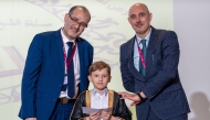 Officials with a winning student. 