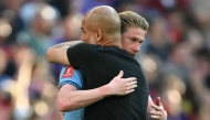 Manchester City's Spanish manager Pep Guardiola (R) embraces Manchester City's Belgian midfielder #17 Kevin De Bruyne (L) on the pitch after the English FA Cup final football match between Crystal Palace and Manchester City at Wembley stadium in London, on May 17, 2025. (Photo by Glyn KIRK / AFP)