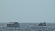 This photograph taken and released on May 25, 2025 by the Indian Defence Public Relations Office (PRO) of Mumbai, shows Liberian-flagged ship's containers after it capsized off India's southern coast of Kerala. (Photo by Indian Defence Public Relations Office (PRO) of Mumbai / AFP) 