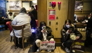 People visit a Starbucks cafe after a political protest in Seoul on December 6.  (Photo by Jintak Han/The Washington Post)
