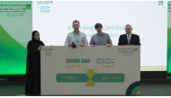 Innovation and Entrepreneurship Director at QSTP, Hayfa Al Abdulla with the first place winning team during the event.