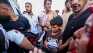 Palestinian rescuers evacuate injured people in an ambulance after an Israeli drone reportedly opened fire on civilian gatherings near an aid distribution point not far from the so-called 