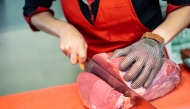 Woman cutting meat. Photo from Freepik.