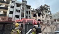 First-responders gather outside a building that was hit by an Israeli strike in Tehran on June 13, 2025. Photo by MEGHDAD MADADI / TASNIM NEWS / AFP.
