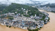 Flooded buildings are seen in Congjiang, in China's southwest Guizhou province on June 24, 2025. (Photo by AFP)