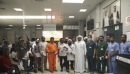 Some of the participating workers with QCS officials in a group photo during the campaign.