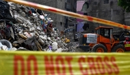 A rescue worker is pictured during a search operation amidst the debris of a collapsed building in Karachi on July 5, 2025. Photo by Rizwan TABASSUM / AFP