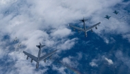 This handout photo taken on July 11, 2025 and provided by South Korean Defence Ministry shows US Air Force B-52H bombers (C), South Korean Air Force KF-16 fighter jets (L) and Japanese Air Self-Defense Force F-2 fighter jets (R) flying in formation during a joint air drill over international waters off South Korea's southern island of Jeju. (Photo by Handout / South Korean Defence Ministry / AFP) 