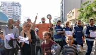 Demonstrators and journalists march in a protest against hunger in the Rimal district of Gaza City on July 19, 2025. (Photo by Omar AL-QATTAA / AFP)