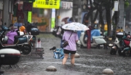 A pedestrian wades through a flooded area in Haikou, south China's Hainan Province, July 20, 2025. Typhoon Wipha, the sixth typhoon of the year, made landfall near Jiangmen City in south China's Guangdong Province around 5:50 p.m. on Sunday. (Xinhua/Yang Guanyu)
