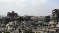 Buildings destroyed in Israeli strikes surround makeshift shelters for displaced Palestinians in Gaza City on August 8, 2025. (Photo by Bashar Taleb / AFP)
