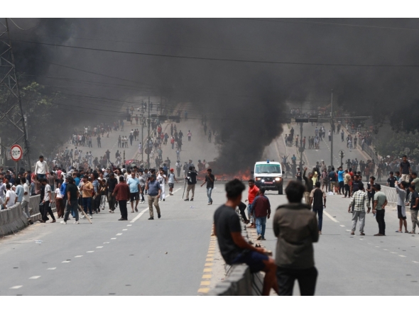 A fire burns as demonstrators gather on a road during a protest to condemn the police's deadly crackdown on demonstrators in Kathmandu on September 9, 2025. (Photo by Prabin Ranabhat / AFP)