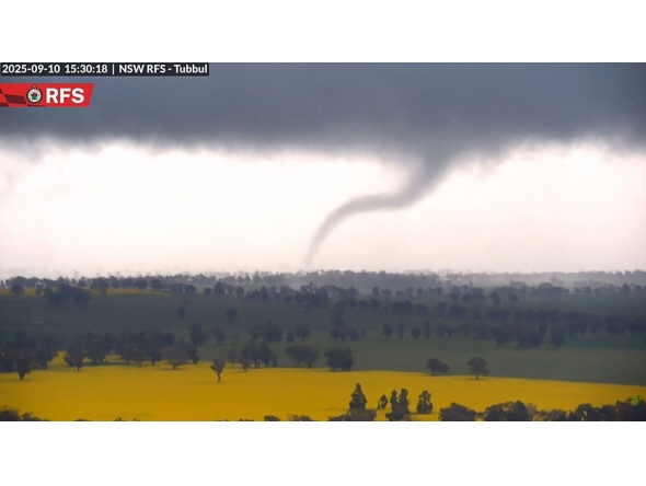 This screengrab from handout surveillance camera footage taken and released by New South Wales Rural Fire Service (NSW RFS) on September 10, 2025 shows a tornado over the countryside near Young in New South Wales. (Photo by Handout / NSW Rural Fire Service (NSW RFS) / AFP) 
