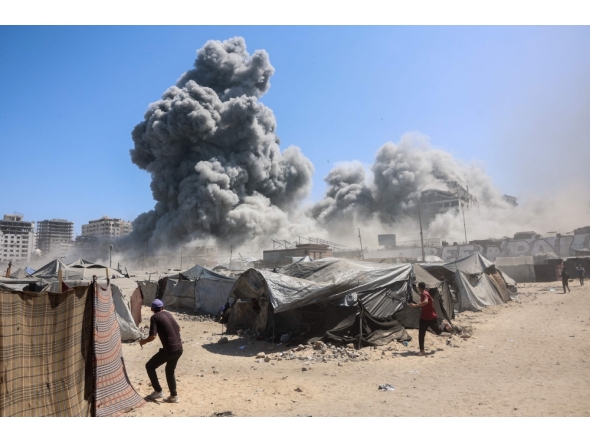 Smoke billows in Gaza City after Israeli strikes on a tower on September 10, 2025. (Photo by Omar Al-Qattaa / AFP)

