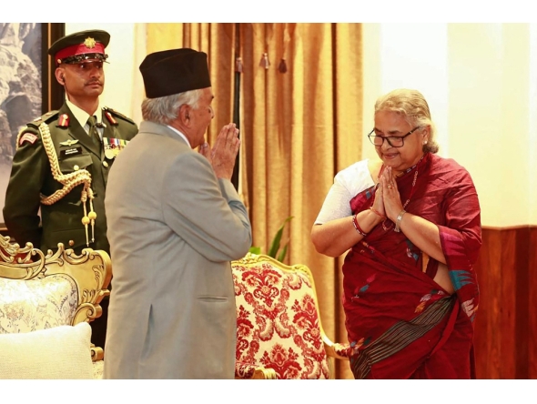 Nepal's President Ram Chandra Paudel gestures after administering the oath to the country's newly appointed Prime Minister Sushila Karki during her swearing-in-ceremony at the President House in Kathmandu on September 12, 2025. (Photo by Sujan Gurung / AFP)
 
